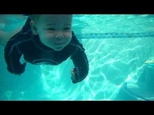 Talented baby jumps in and swims across pool