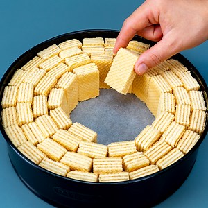 895K views · 4.2K reactions | The famous dessert that drives the whole world crazy! Ingredients milk: 100 ml (3.4 fl oz) wafers: 600 g (21 oz) eggs: 2 pc sugar: 100 g (3.5 oz) lemon: 1 pc corn starch: 50 g (1.8 oz) milk: 500 ml (17 fl oz) white chocolate: 80 g (2.8 oz) The drink ice: 60 g (2.1 oz) vanilla essence: 5 ml (0.2 fl oz) coffee: 120 ml (4.1 fl oz) cocoa: 20 g (0.7 oz) milk: 80 ml (2.7 fl oz) | Cookrate | Facebook