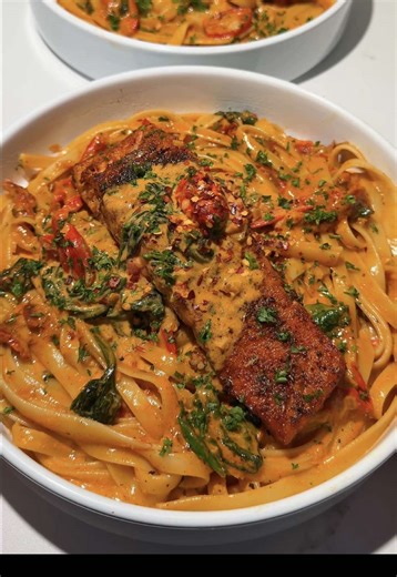 Creamy Tuscan salmon pasta ✨ Tuscan salmon pasta Ingredients Salmon - 4 salmon filets - 1/2 tbsp roasted garlic algae oil (or any oil of choice) - 1 tsp smoked paprika - 1 tsp garlic powder - 1 tsp oregano - 1/2 tsp basil - 1/2 tsp old bay - Salt and pepper to taste Pasta/sauce - 12 oz fettuccine - 3 tbsp butter - 1 tbsp sun-dried tomato oil - 1 shallot, diced - 6 garlic cloves, minced - 3 oz grape tomatoes, sliced - 1/4 cup sun dried tomatoes - 1 1/2 cup heavy cream - 1/3 cup white wine or chic