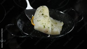 cooking and flipping a fresh cod loin in the pan