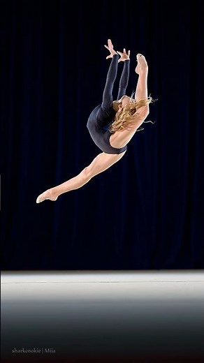 Rhythmic gymnast performing a split jump in slow motion