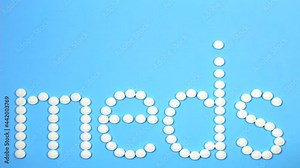 Motion Design. 4K Stop motion word text letters meds on blue backgroun. Pharmacy symbol, medicine symbol. Animated Meds lettering