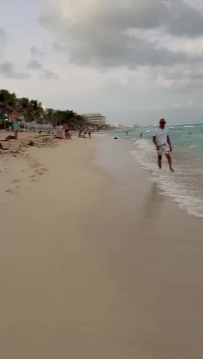 Relaxing Beach Walk: Man Strolling on Sandy Shore