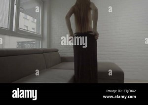 sexy woman taking off her dress in the room Stock Video Footage - Alamy