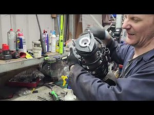 How do you replace the driver's side spring in a Ford Transit Mark 8?