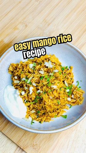 Easy Mango Rice / Mango Pulao Recipe In a mortar and pestle, add garlic, ginger, and green chilli. Crush them into a fine paste. Heat 3 tablespoons of ghee in a pan. Once the ghee is hot, add 1 teaspoon of mustard seeds. Let them splutter. Then add the ginger-garlic-green chilli paste and sauté until it turns golden brown. Add finely chopped onions and sauté until soft and translucent. Add ripe mango pieces add jaggery powder , salt to taste, turmeric powder, chilli powder, and black pepper. Mix