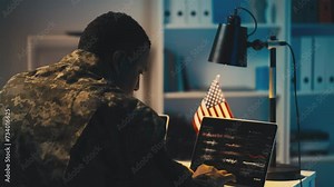 U.S. soldier working on computer in defense department, collecting intelligence