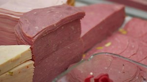 Different varieties of deli meats displayed in a market