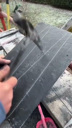 The process of a fireplace on a special material by a man using a special tool