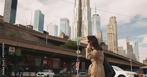 Happy free woman walking in dynamic and thriving New York City streets on bright day