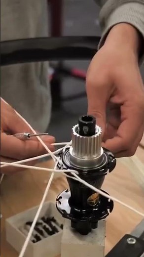 The process of installing spokes on a bicycle rim neatly and carefully by a man