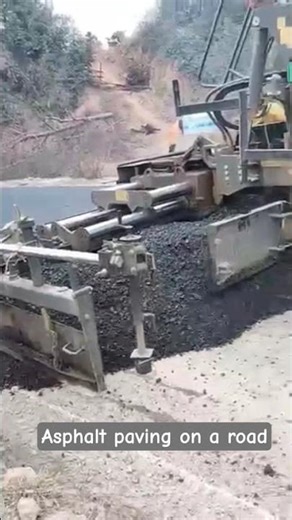 Heavy Equipment Road Construction: Paver and Dump Truck Synergy