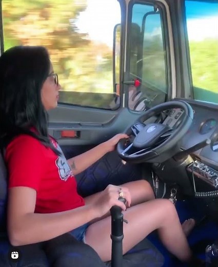 Girl driving truck barefoot.