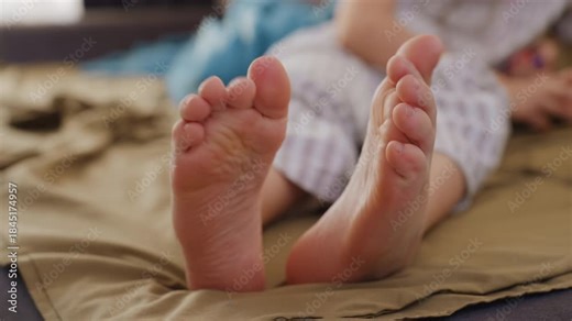 Relaxed Woman Wiggling Toes, Casual Moment With Toes On Bedspread, Woman In Striped Pajamas Playing With Her Toes On Bed, Woman In Cozy Pajamas Wiggling And Flexing Her Toes Leisurely On Bed