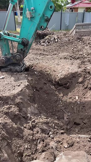 Excavator in Action: Digging and Moving Soil on Site