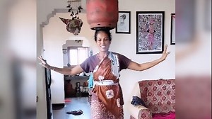 Woman dances with gas cylinder on her head. But, there is more to this video