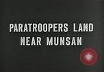 U.S. Army Paratroopers of 187th Regimental Combat Team jump into area near Munsan, Korea during Korean War.