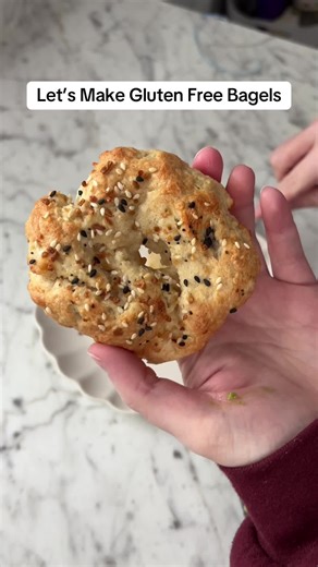 Gluten Free Bagel Recipe 🥯: 1. Mix 1 cup gf bread flour (can sub with 3/4 c 1:1 flour 1/4 c tapioca starch), 1/2 c Greek yogurt, 1 tsp baking powder, 1/2 tsp salt until a shaggy dough is formed 2. Roll & shape 2-3 bagels on floured surface, let rest 10 minutes 3. Add 1 tbsp of honey to boiling water. Boil your bagels for 30 seconds and transfer to a baking sheet. Add any toppings now. Let rest another 10 minutes 4. Bake at 350° until golden #glutenfree #glutenfreerecipes #glutenfreebagels #glut
