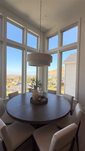 Soft, sculptural, and perfectly centered. This pendant anchors the dining nook while letting the views and natural light do their thing. #DiningNook #CeilingStatement #HomeInspo #ThoughtfulInteriors #ElevatedLiving || dining nook lighting, drum pendant, sculptural pendant, cozy dining space, statement ceiling fixture