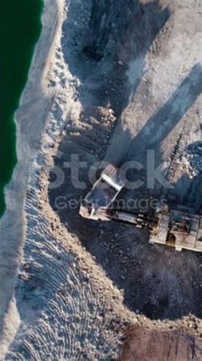 mining quarry with lots of machinery at work - extracting