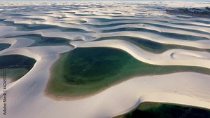Panoramic landscape of Lencois Maranhesn Brazil. Scenic sand dunes and turquoise rainwater lakes. World travel destinations. Tropical scenery.