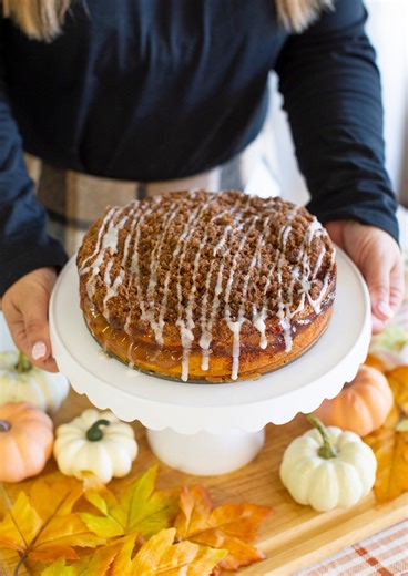 Easy Fall Recipe! With just a few ingredients and a box of Krusteaz Cinnamon Swirl Crumb Cake Mix, you can whip up this delicious Apple Cinnamon Crumb Cake. Your whole kitchen will totally smell like fall! Krusteaz Apple Cinnamon Crumb Cake Ingredients For the Cake: * 1 (21 oz) box Krusteaz Cinnamon Swirl Crumb Cake Mix * 1 cup milk * ½ cup sour cream * 1 egg * 1 (21 oz) can apple pie filling For the Icing: * ¾ cup powdered sugar * 1 tablespoon water Instructions 1. Preheat the oven to 350°F. 2.