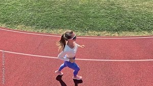 Woman Running on an Outdoor Track, Embracing Freshness and Vitality. Energize Your Workout with the Freedom of Open-Air Fitness. Experience the Perfect Blend of Endurance.