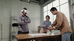 Asian people Architects teamwork using tablet and Virtual Reality headset working with Augmented Reality software application. Augmented reality technology for engineering in the future.