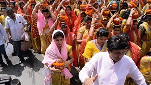 Download New Delhi, India April 03 2022 - Women with Kalash on head during Jagannath Temple Mangal Kalash Yatra, Indian Hindu devotees carry earthen pots containing sacred water with a coconut on top