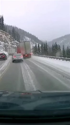 Civil Engineer on Instagram: "Semi Loses Control on Icy Mountain Curve, Trailer Slides Off Roadway Colorado Rockies — A winter drive through a mountain pass turned dangerous when a semi truck lost traction on an ice-covered curve, sending its trailer sliding off the roadway and into the trees as nearby drivers struggled to stop. Dashcam footage shows cars creeping along the snow-packed road when the tractor-trailer ahead begins to drift. The trailer swings wide, scraping past the guardrail befor