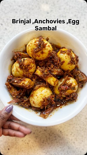 If you’re looking for a quick, spicy sambal with egg, brinjal (eggplant), and anchovies, something bold, flavorful, and ready in a flash. Here’s a simple method that works well for a weekday dinner or lunch: 1. Boil eggs, peel, and set aside. 2. Fry anchovies until golden and crispy, then set aside. 3. Blend or pound shallots, garlic, ginger, red and green chilies, and bird’s eye chilies into a rough paste. 4. Dry-fry brinjal cubes until soft and slightly browned, then set aside. 5. Heat oil in 