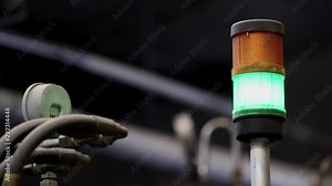 Factory machine indicator light. Light blinking on a factory machine. Production line indicator, The green lamp is blinking. Manufacturing indicator.
