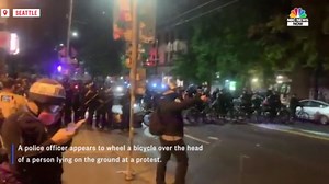 Video of Seattle officer appearing to roll over protester's head with bike prompts probe