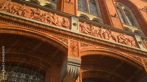 Detailed view of the red-brick exterior of Berlin’s Rotes Rathaus, adorned with intricate carvings and architectural flourishes, reflecting its historical importance
