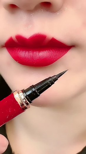Creative Lip Art with Red Lipstick and Eyeliner