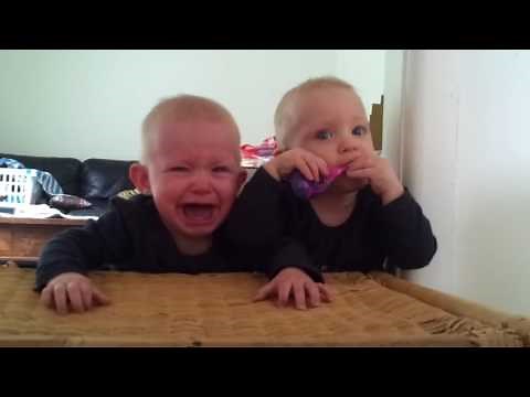 Babies crying. Twins and a toothbrush