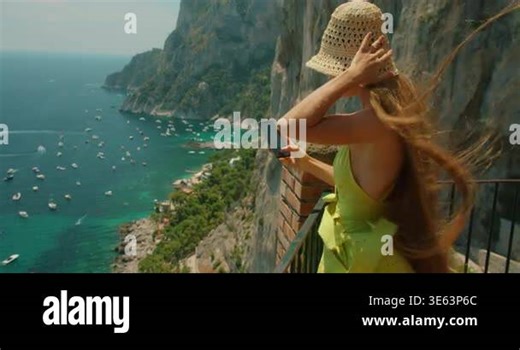 Woman admires the view of Marina Piccola from a cliffside terrace in Capri Italy in summer Stock Video Footage - Alamy