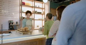 African American Barista Serving Customers at a Cafe Counter