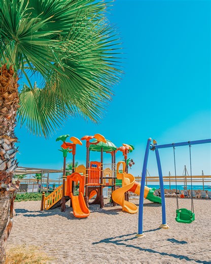 The best games are played on the beach! This special playground on the Serra Palace shore is an adventure base for our little guests. They swing up to the sky and slide onto the sand from colorful slides. Let them play and build sandcastles; you just sit back and enjoy the Mediterranean. Your children's joy is the melody of your holiday. #SerraPalaceHotel #CalimeraSerraPalace #SerraPalaceExperience #Antalya #Turkey | Calimera Serra Palace