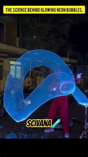 A street performer showcases the beautiful bubbles of neon gas.