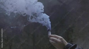 Slow Motion Lockdown: Man Holding Distress Flare Emitting Smoke