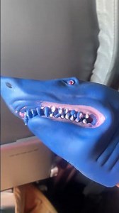 shark puppet hears a baby crying on a plane