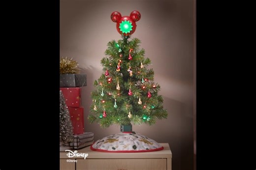 A magical, mini tree for Disney fans? Oh boy! ❤️ 🤍 Pick up the ShowToppers mini tree and the topper at Ornament Premiere in July and you'll save $10. For more details, visit: https://bit.ly/DisneyTreeHallmark | Hallmark Gold Crown Stores