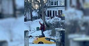 Woman poses for selfie atop sinking car after trying to drive on frozen river in Canada