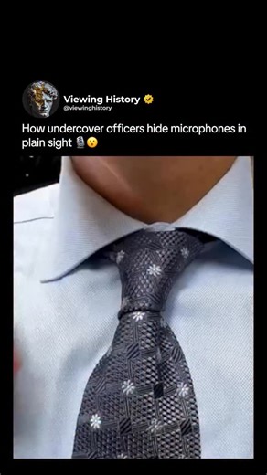 @viewinghistory on Instagram: "Sometimes the most effective tools are the ones you never notice. In this clip, an agent discreetly hides a microphone in plain sight — threading it through a tie loop and positioning it so it stays hidden while still capturing clear audio. It’s a simple technique, but one that’s been used for decades in surveillance, investigations, and undercover work. The goal isn’t high-tech gadgets or flashy equipment — it’s subtlety, placement, and blending in without drawing