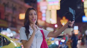 Asian young women vlogger using camera record vlog while travel in city.
