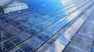 Tilt up from glass structure pattern of greenhouse to house and farm in countryside