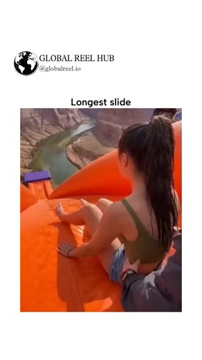 GLOBAL REEL HUB™ on Instagram: "The post shares a 10-second video of a woman accelerating down an extraordinarily long orange inflatable slide into a turquoise river surrounded by red canyon walls, likely near Horseshoe Bend in Arizona, captioned simply "Longest slide" for maximum viral appeal. With 1.3 million views and 100+ replies in under 24 hours, it sparks amusement and awe, but also skepticism, as users debate its authenticity amid rising AI-generated adventure clips, though no peer-revie