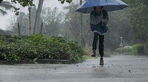 Boy jumping in puddles of water during the rain - Free Stock Video