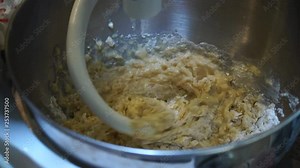 Dough hook on stand mixer kneading chunky bread mix, Slow Motion Close Up